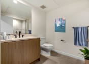 Thumbnail 3 of 38 - a bathroom with a toilet sink and mirror
