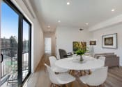 Thumbnail 15 of 38 - a dining area with a round table and white chairs