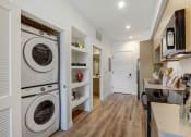 Thumbnail 10 of 38 - a laundry room with a washer and dryer