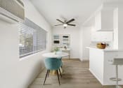 Thumbnail 11 of 24 - a dining room with a small table and a ceiling fan