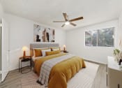 Thumbnail 14 of 24 - a bedroom with a bed and a ceiling fan