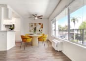 Thumbnail 4 of 24 - a dining room with a table and chairs and a balcony