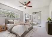 Thumbnail 7 of 24 - a bedroom with a large bed and a ceiling fan