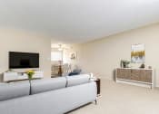 Thumbnail 9 of 35 - a living room with a couch and a chair and a tv