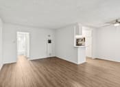 Thumbnail 54 of 61 - A room with wooden floors and white walls.