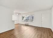 Thumbnail 55 of 61 - A room with wooden floors and white walls.