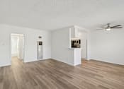 Thumbnail 42 of 61 - A room with a wooden floor and a ceiling fan.