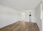Thumbnail 43 of 61 - A room with wooden flooring and white walls.