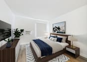 Thumbnail 6 of 76 - A modern bedroom with a large bed and a painting on the wall.