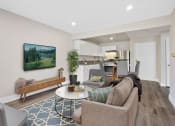 Thumbnail 10 of 52 - a living room with a couch and a chair in front of a tv