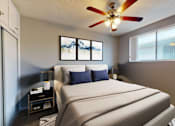 Thumbnail 5 of 9 - A bedroom with a large bed and a ceiling fan.