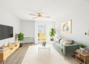 Thumbnail 5 of 52 - a living room with a green couch and a ceiling fan