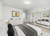 Thumbnail 4 of 19 - a bedroom with a bed and a mirror