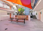 Thumbnail 64 of 66 - a courtyard with a wooden bench and a table