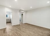 Thumbnail 44 of 66 - a living room with white walls and a wooden floor