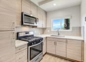 Thumbnail 42 of 66 - an updated kitchen with stainless steel appliances and wooden cabinets