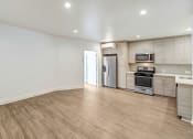 Thumbnail 51 of 66 - an empty living room with white walls and wood flooring