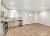 Thumbnail 52 of 66 - an empty room with a kitchen and a living room