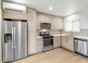 Thumbnail 49 of 66 - a kitchen with stainless steel appliances and a refrigerator