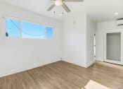 Thumbnail 53 of 66 - an empty living room with white walls and a wooden floor