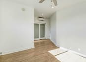 Thumbnail 55 of 66 - a living room with white walls and wood flooring and a ceiling fan