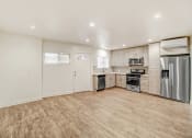 Thumbnail 36 of 66 - an empty kitchen with stainless steel appliances and a wooden floor