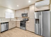 Thumbnail 34 of 66 - a kitchen with stainless steel appliances and a refrigerator