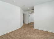 Thumbnail 38 of 66 - an empty room with white walls and a wooden floor