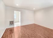 Thumbnail 49 of 79 - A room with wooden flooring and a fireplace.