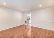 Thumbnail 48 of 79 - A room with wooden flooring and white walls.
