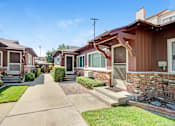 Thumbnail 4 of 13 - a row of houses with a sidewalk in front of them