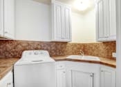 Thumbnail 5 of 13 - a white kitchen with white appliances and white cabinets