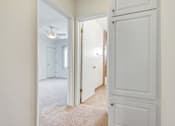 Thumbnail 12 of 13 - a bedroom with a door to a hallway and a closet