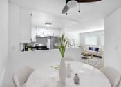 Thumbnail 3 of 46 - a white kitchen and dining room with a white table