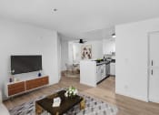 Thumbnail 2 of 46 - a living room with a table and a television
