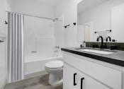 Thumbnail 7 of 46 - a bathroom with a sink and a toilet and a shower