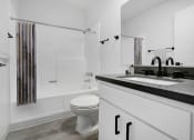 Thumbnail 8 of 46 - a bathroom with a sink and a toilet