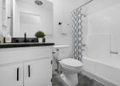 Thumbnail 9 of 46 - a bathroom with a toilet and a shower