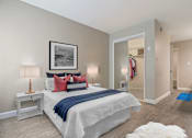 Thumbnail 40 of 76 - Bedroom with a mirrored closet doors, wood-inspired floors