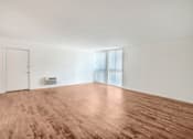 Thumbnail 40 of 48 - an empty living room with wood floors and white walls