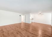 Thumbnail 39 of 48 - an empty living room with wood floors and white walls