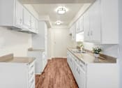 Thumbnail 38 of 48 - a large white kitchen with white cabinets and a wood floor