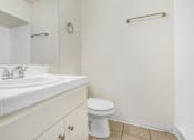 Thumbnail 35 of 48 - a bathroom with a sink and a toilet and a mirror