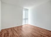 Thumbnail 43 of 48 - the living room of an apartment with wood flooring and white walls