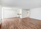 Thumbnail 29 of 48 - the living room and kitchen of an apartment with wood flooring and a ceiling fan