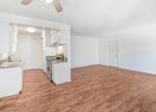 Thumbnail 28 of 48 - an empty living room and kitchen with a wood floor