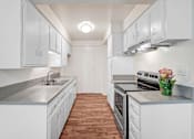 Thumbnail 27 of 48 - a white kitchen with white cabinets and stainless steel appliances