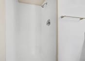 Thumbnail 45 of 48 - a white bathroom with a shower and a towel rack