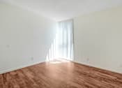 Thumbnail 32 of 48 - an empty living room with wood flooring and a window