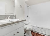 Thumbnail 36 of 48 - a white bathroom with a sink and a toilet